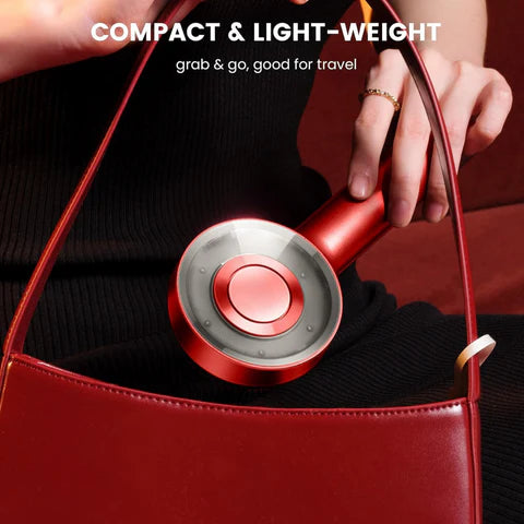 Virrelo compact and lightweight hair massager, shown fitting perfectly in a red handbag, ideal for travel.